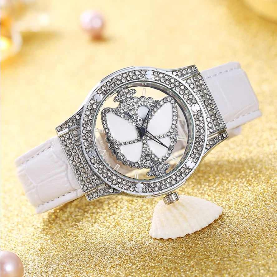 Reloj de cuarzo de cuero con diamantes de imitación de cristal brillante y mariposa giratoria para mujer a la moda